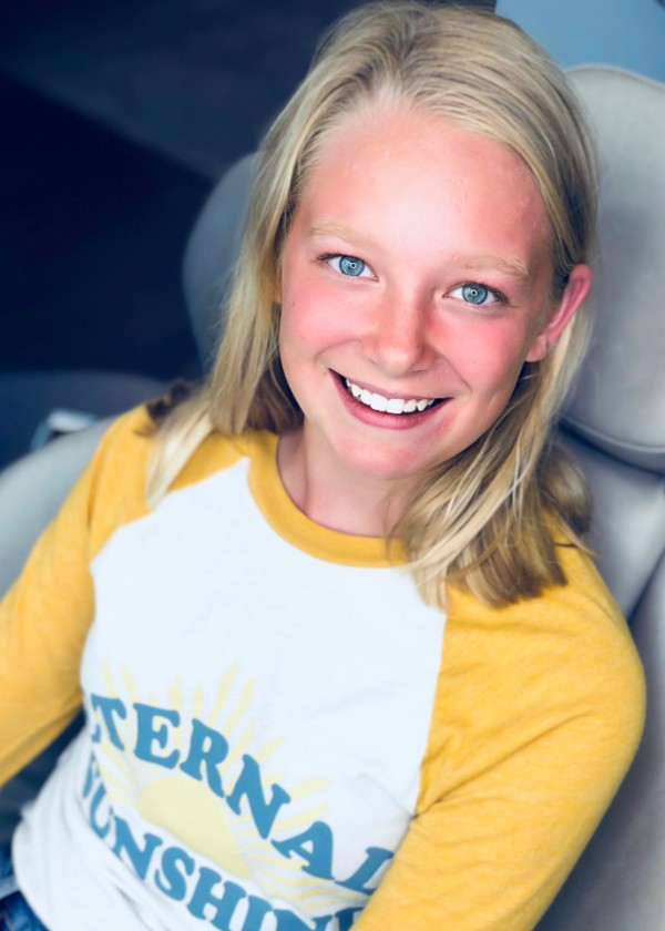 Girl smiling in a car seat